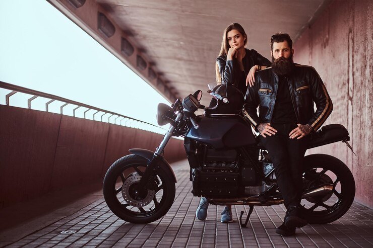 portrait-brutal-fashionable-biker-dressed-black-leather-jacket-with-sunglasses-sitting-his-custom-made-retro-motorcycle-his-young-brunette-girlfriend-who-leaning-his-shoulder_613910-18825 Rev Up Your Day: Exciting car and motorcycle events near Huntington Wv today 2024